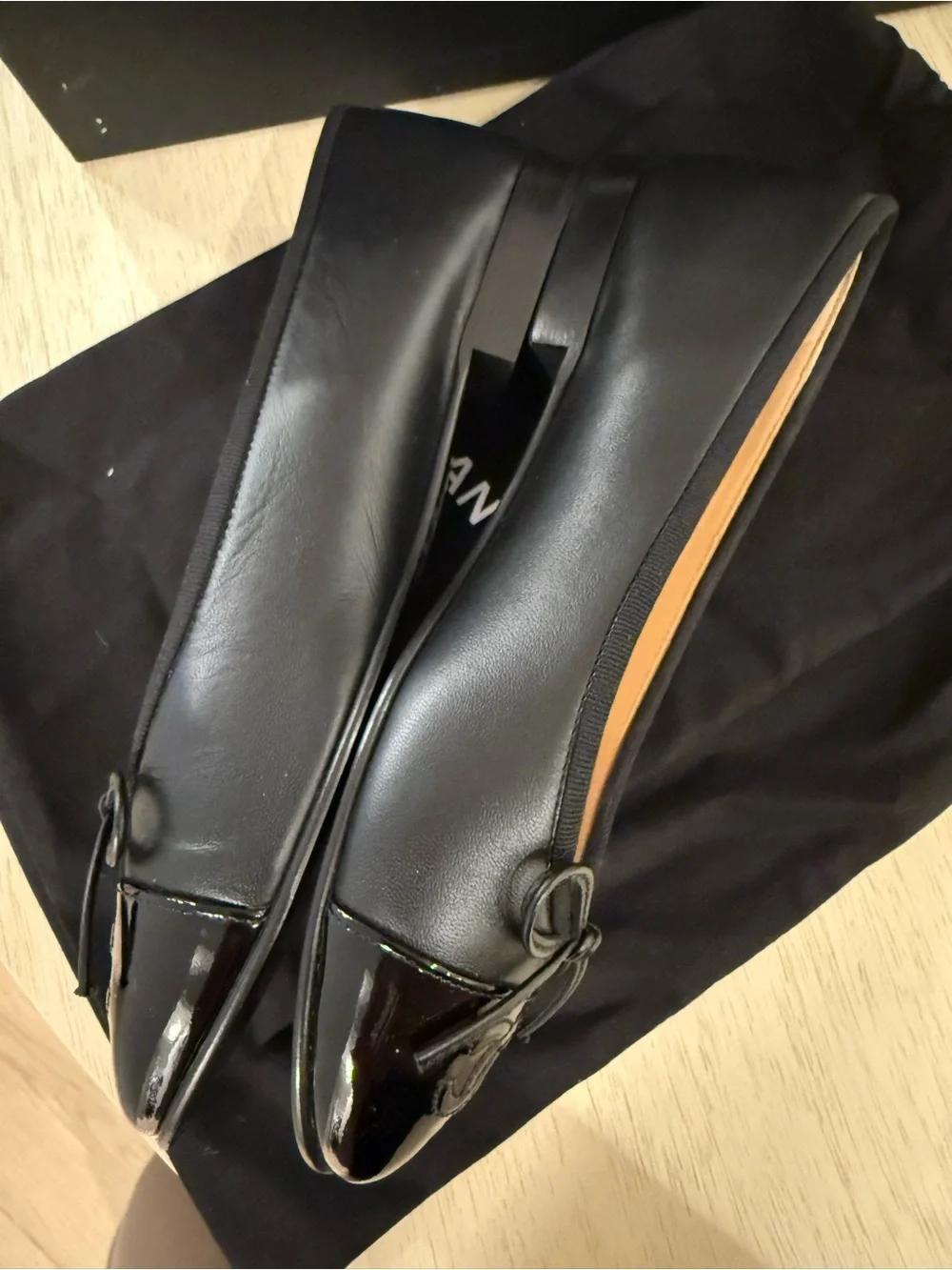 CHANEL Black Leather Cap-Toe Bow Ballet Flats